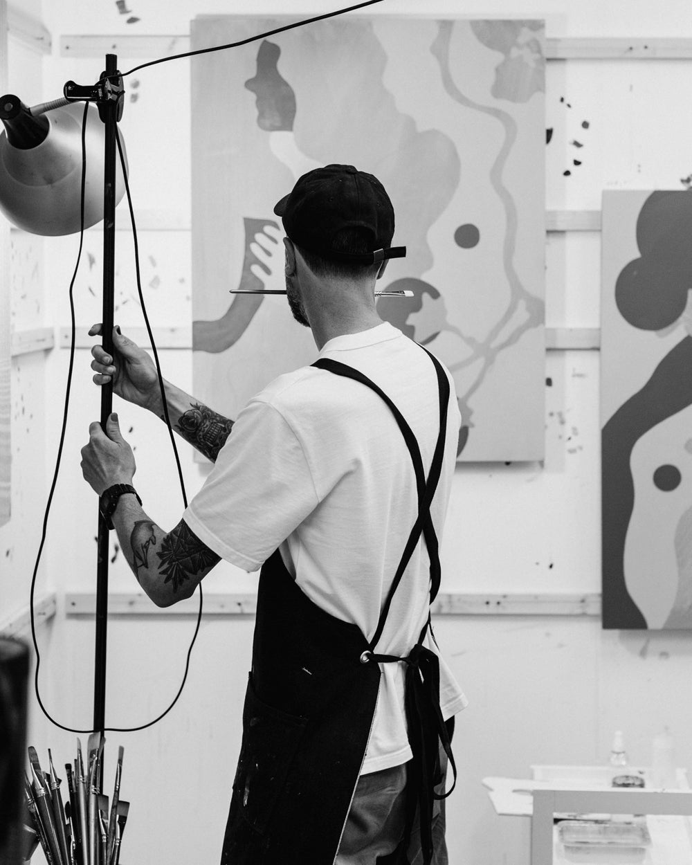 Portrait of UK artist Eelus in his Brighton studio surrounded by art materials