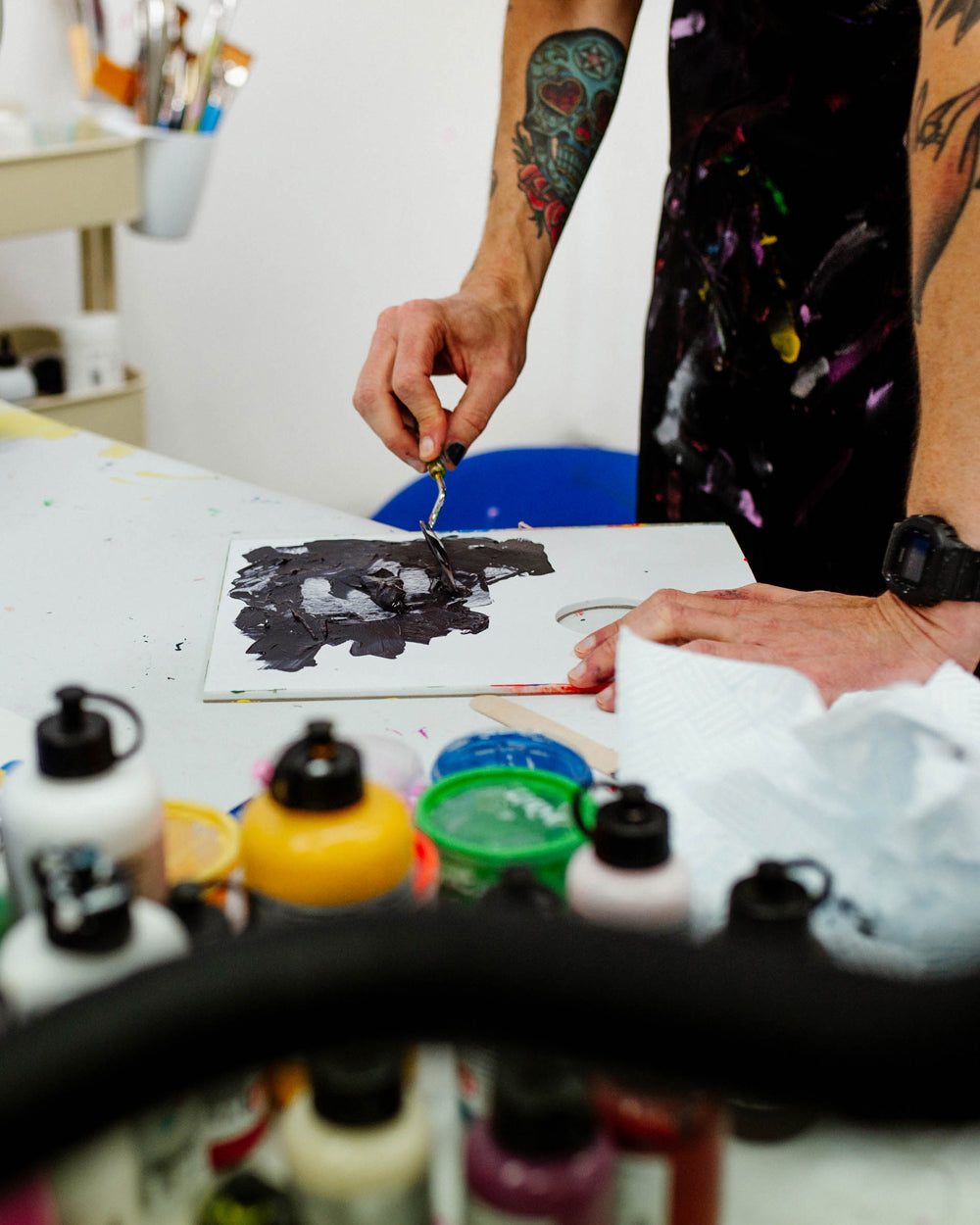 Portrait of UK artist Eelus in his Brighton studio surrounded by art materials