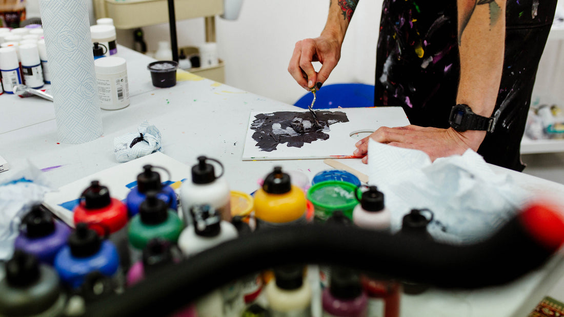 Portrait of UK artist Eelus in his Brighton studio surrounded by art materials